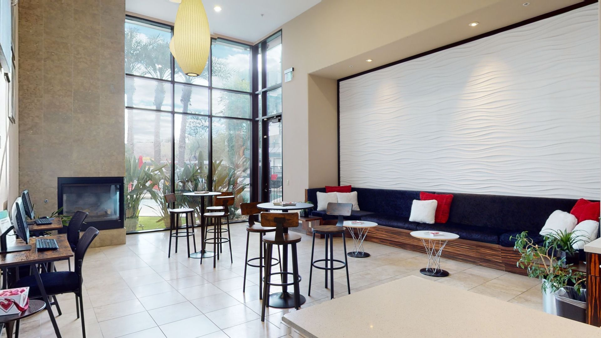 A living room with tables and chairs and a fireplace.