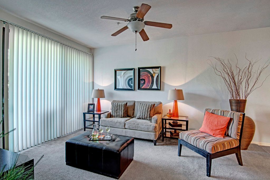 A living room with furniture and a ceiling fan