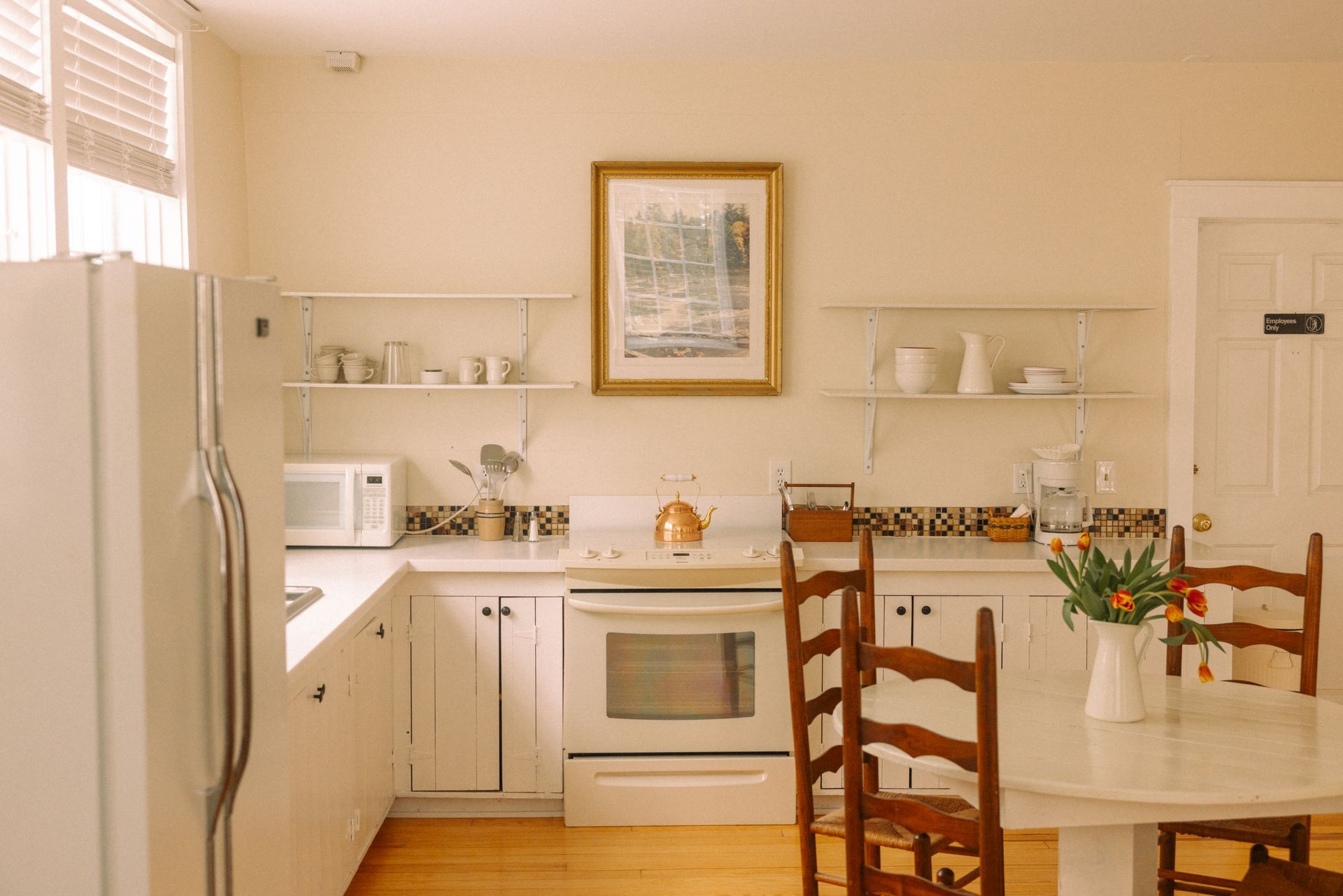 A bedroom with a wicker chair and a bed.