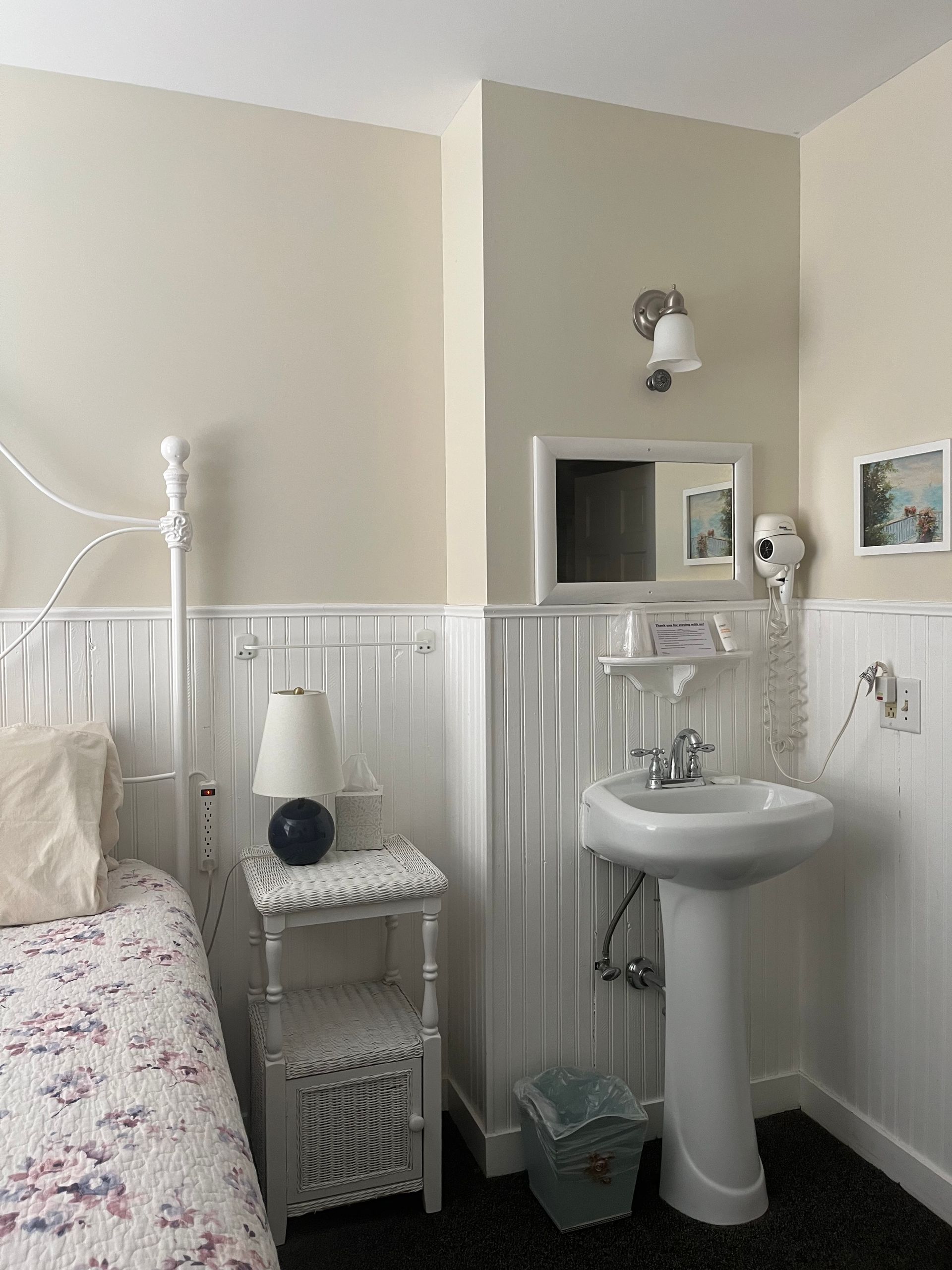 A bathroom with a sink and a mirror on the wall