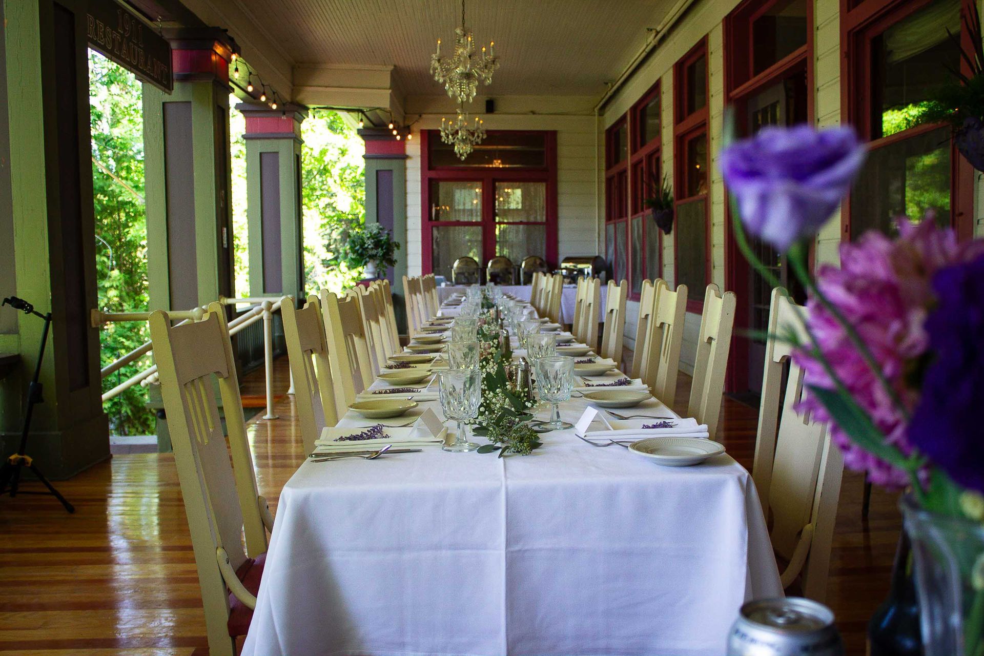 A long table with purple flowers in front of it