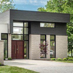 Maison moderne en pierre grise et touches de noir. Portes doubles, grandes fenêtres et une voiture visible.