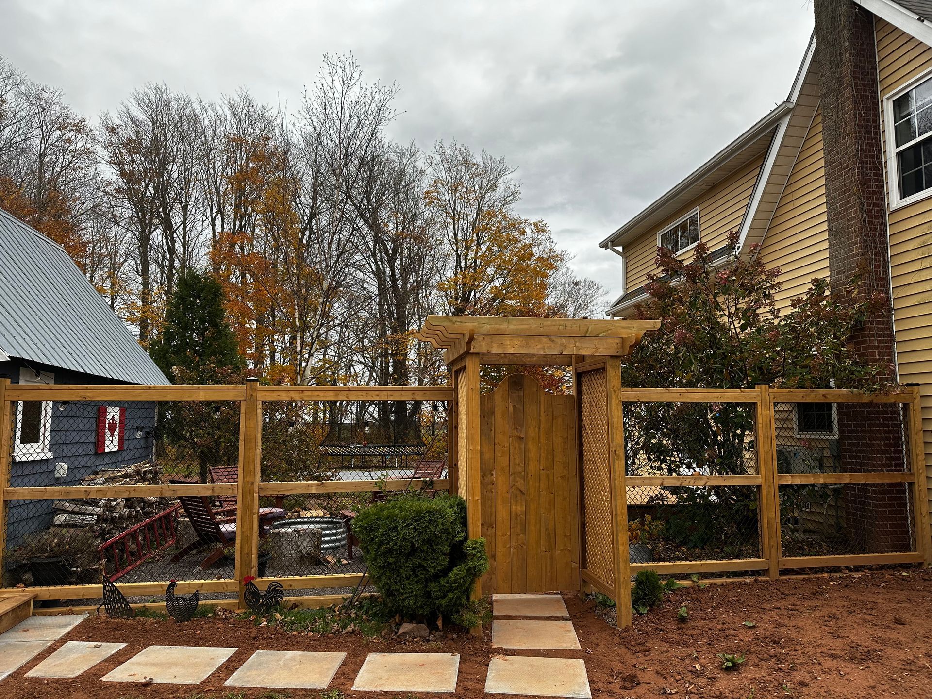 wood frame chain link fence with gazebo entrance pei