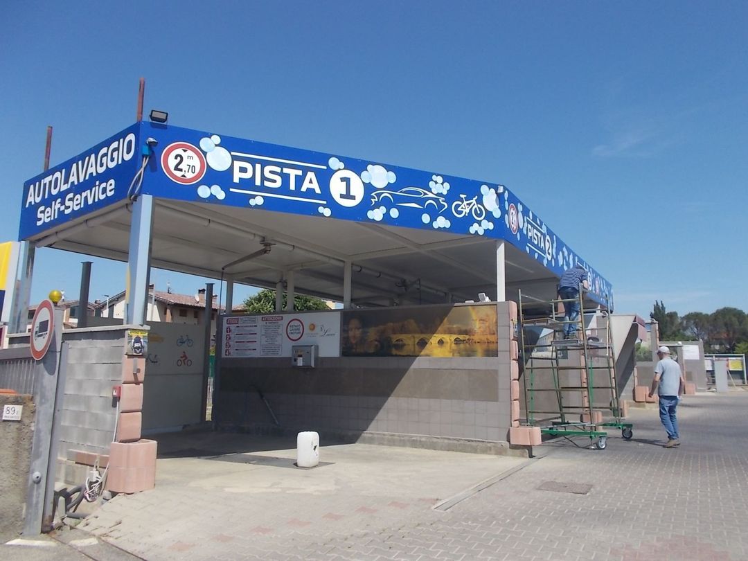 Berlina BMW M3 grigia con cerchi neri e pinze dei freni rosse parcheggiata su una strada.