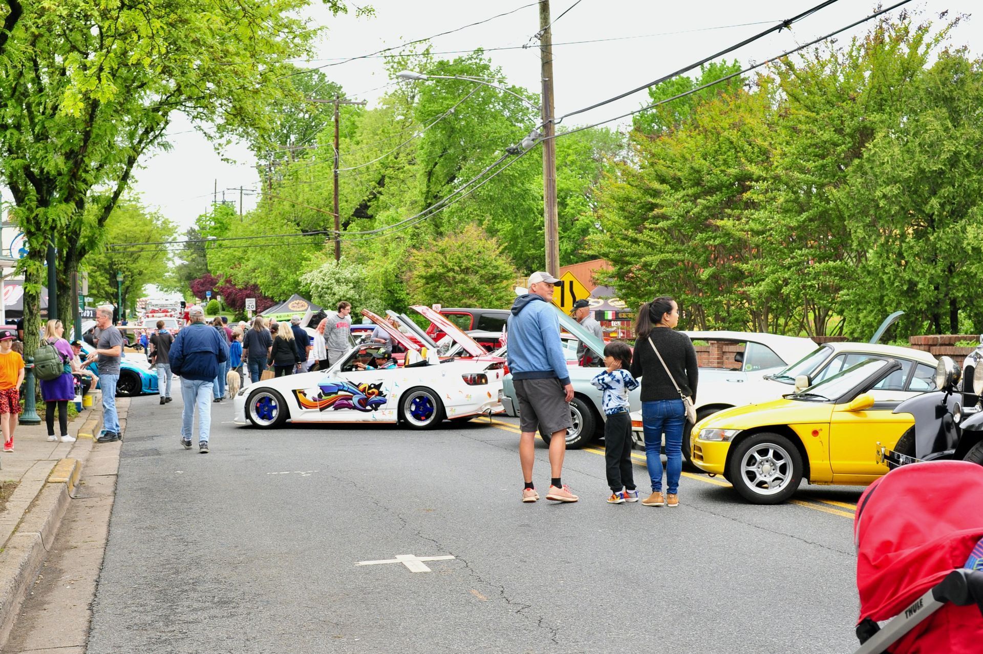 A blue mustang is surrounded by bottles of wine and corks.