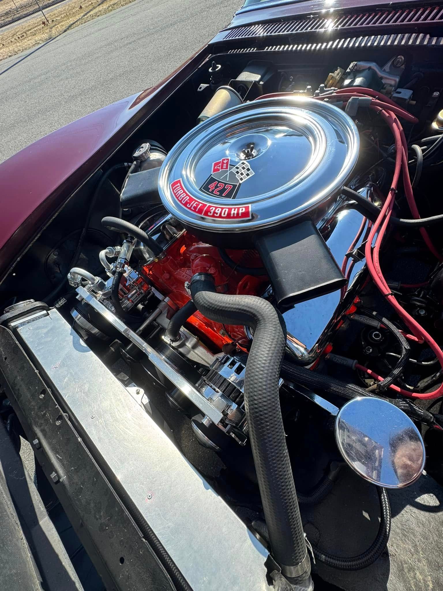 A close up of a car engine with the hood open.
