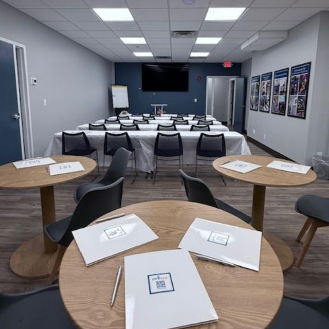 A man is teaching a group of students in a classroom.