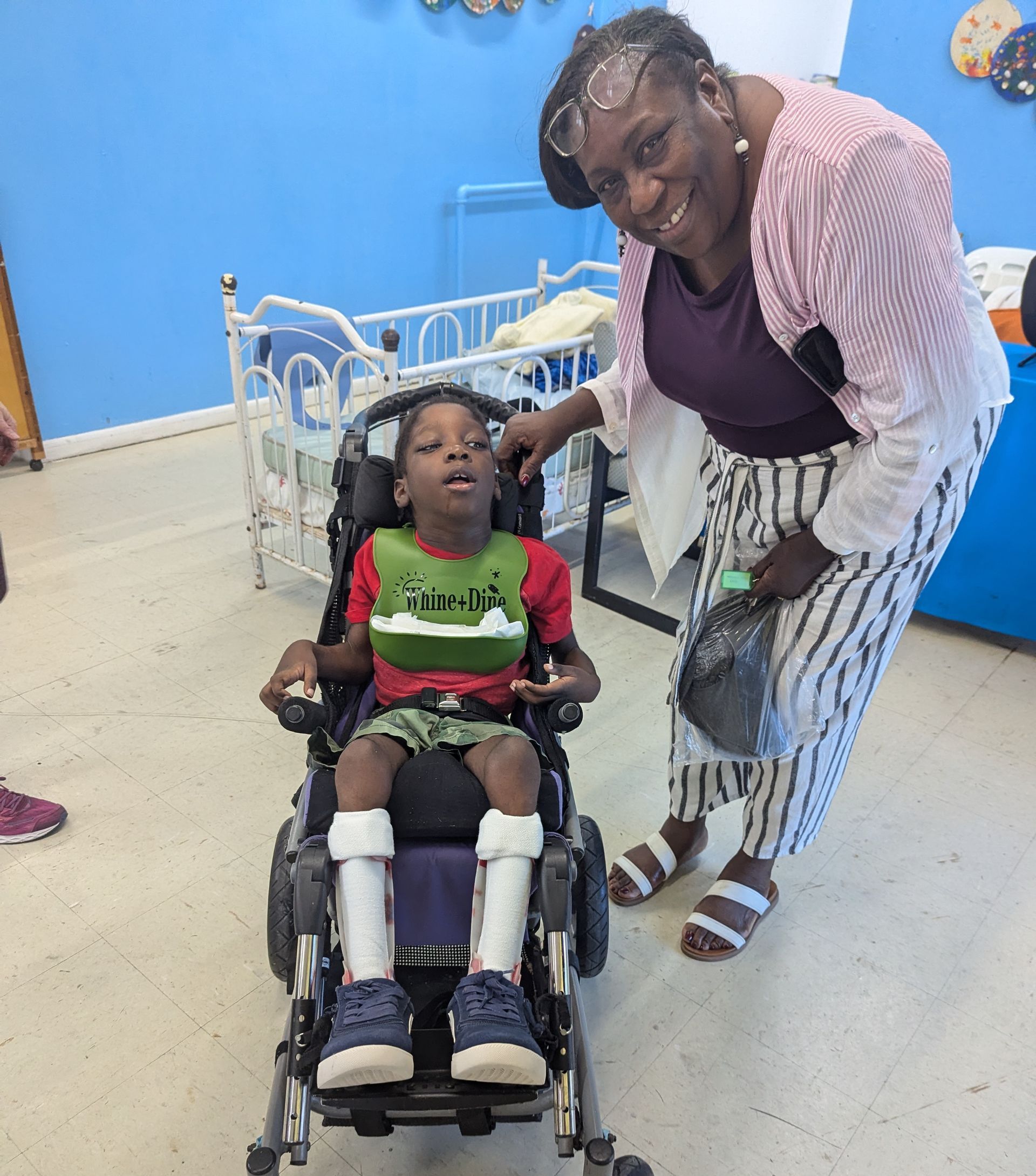 Two women are playing with a baby on a bed.