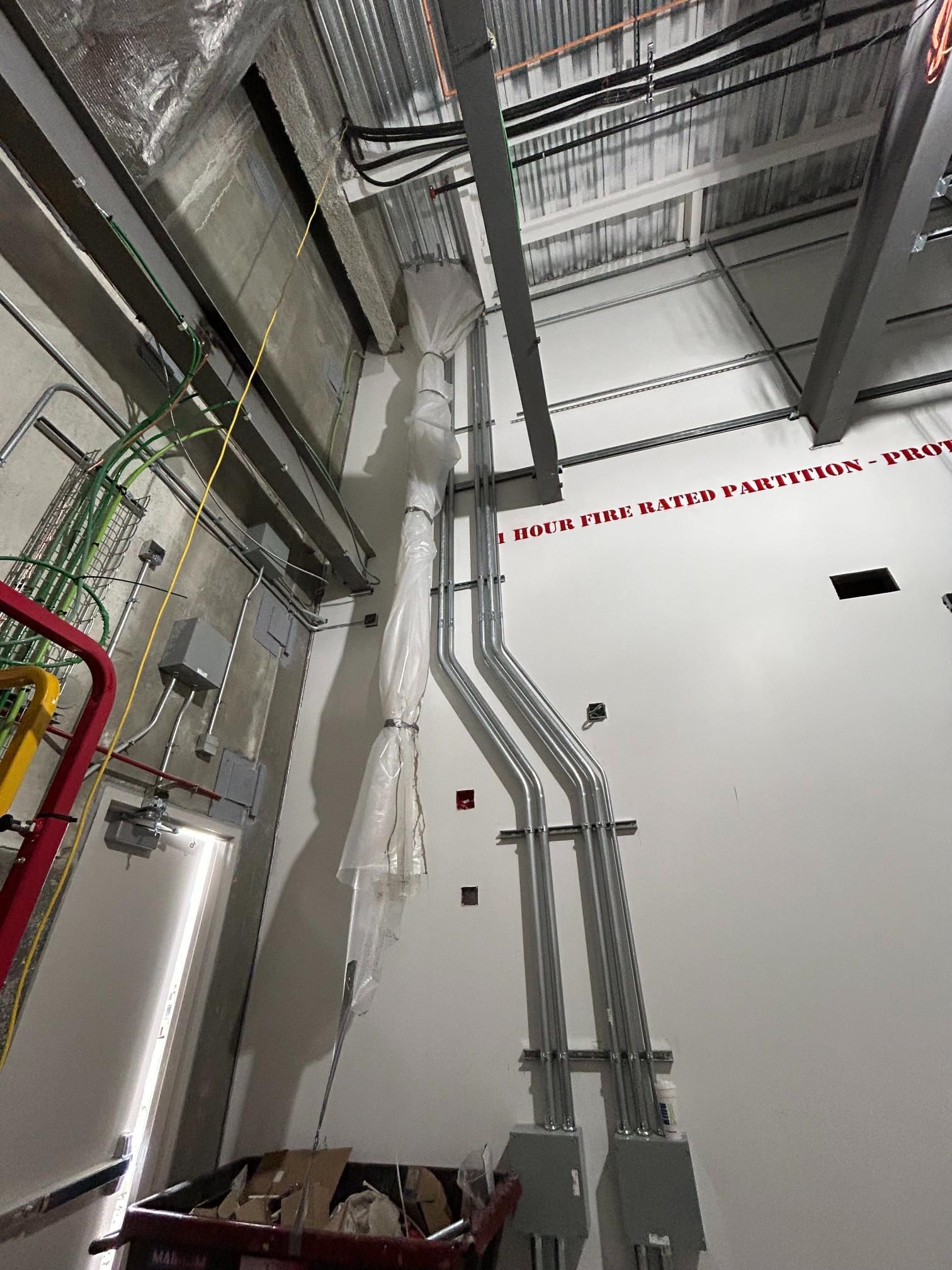 A room with a lot of wires hanging from the ceiling.