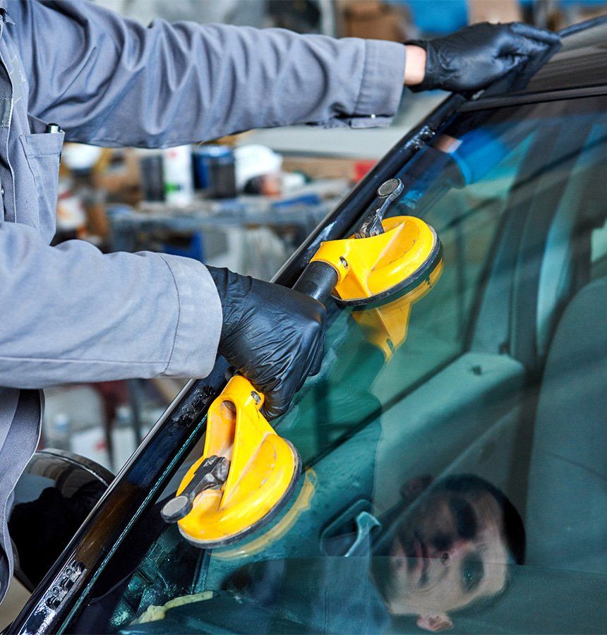 Windshield Replacement — Mechanic Worker Replaces Windshield in Richmond, CA