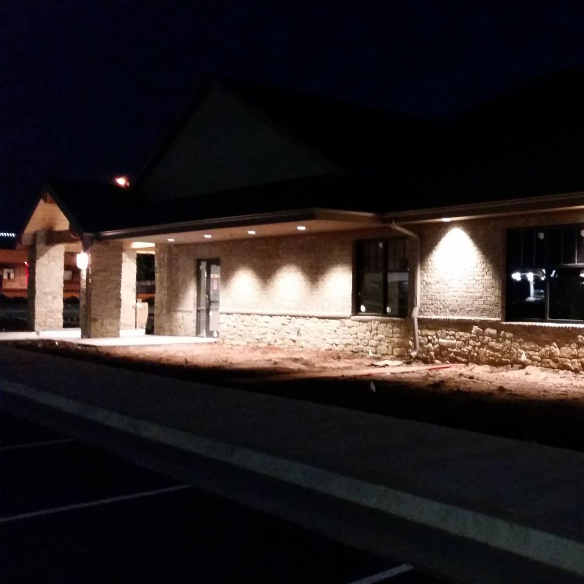Harrington Electric LLC - A building with a lot of windows is lit up at night