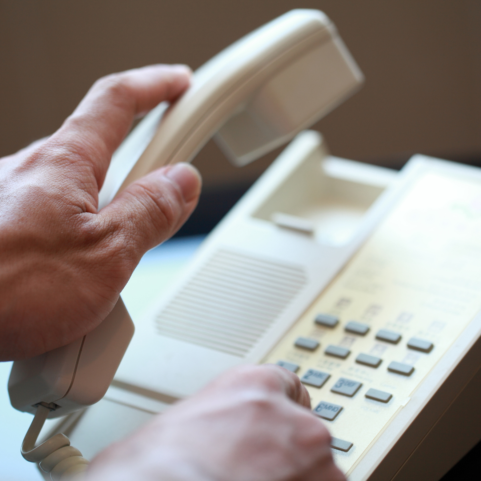 Harrington Electric LLC - A person is dialing a number on a telephone