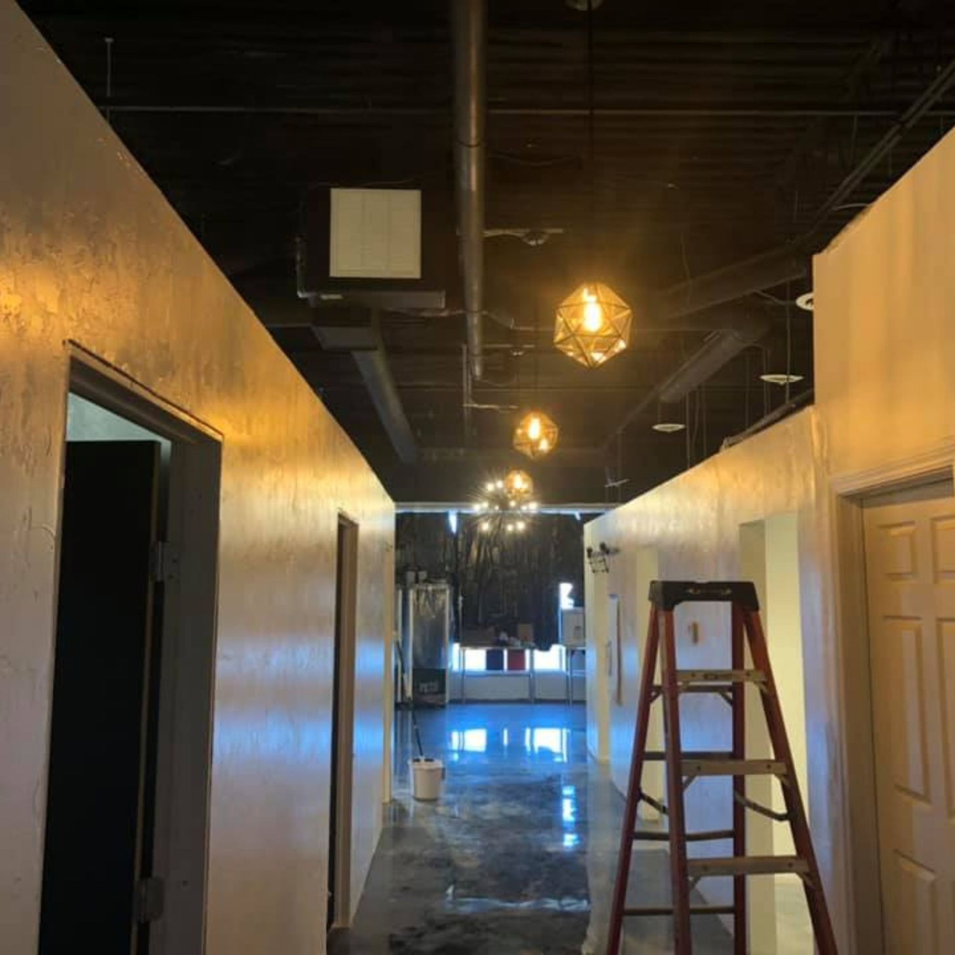 Harrington Electric LLC - A long hallway with a ladder in the middle of it.