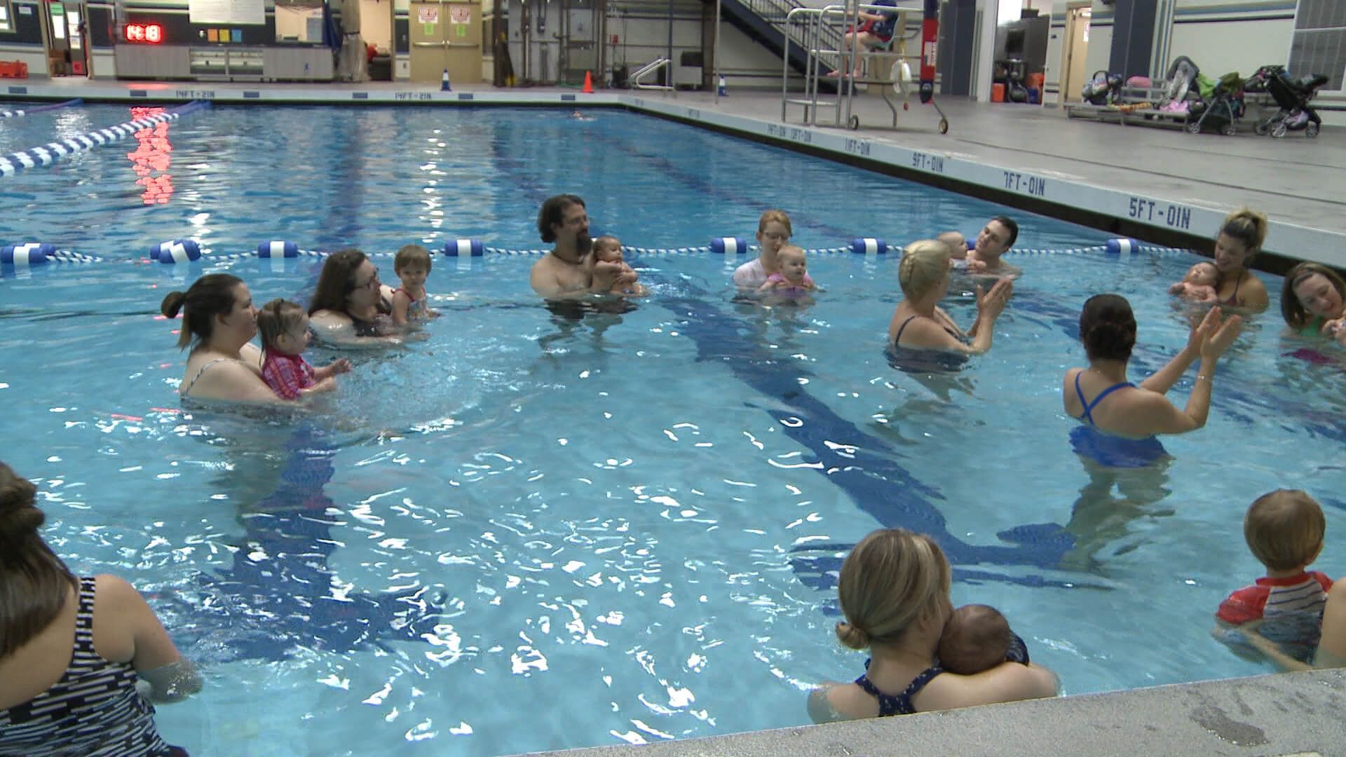 A group of people are playing in a swimming pool.