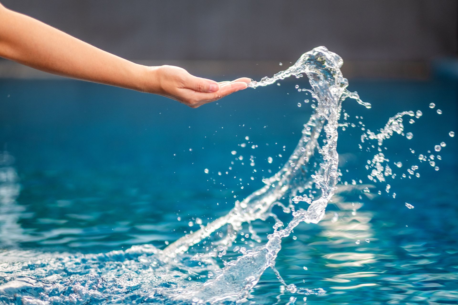 Person splashing pool water