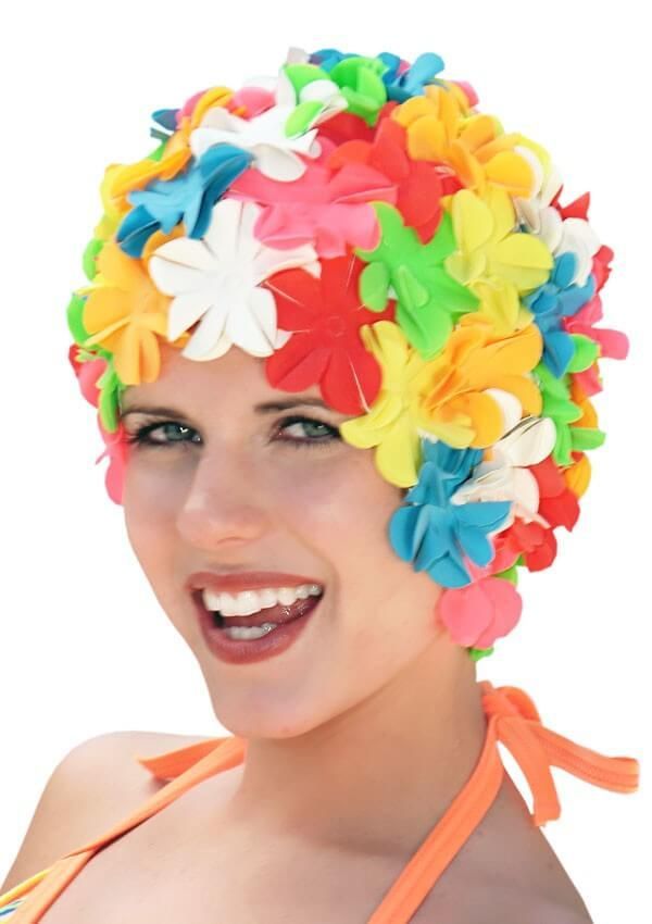 A woman wearing a colorful swim cap with flowers on it