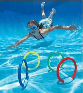 A girl wearing goggles is swimming underwater in a pool