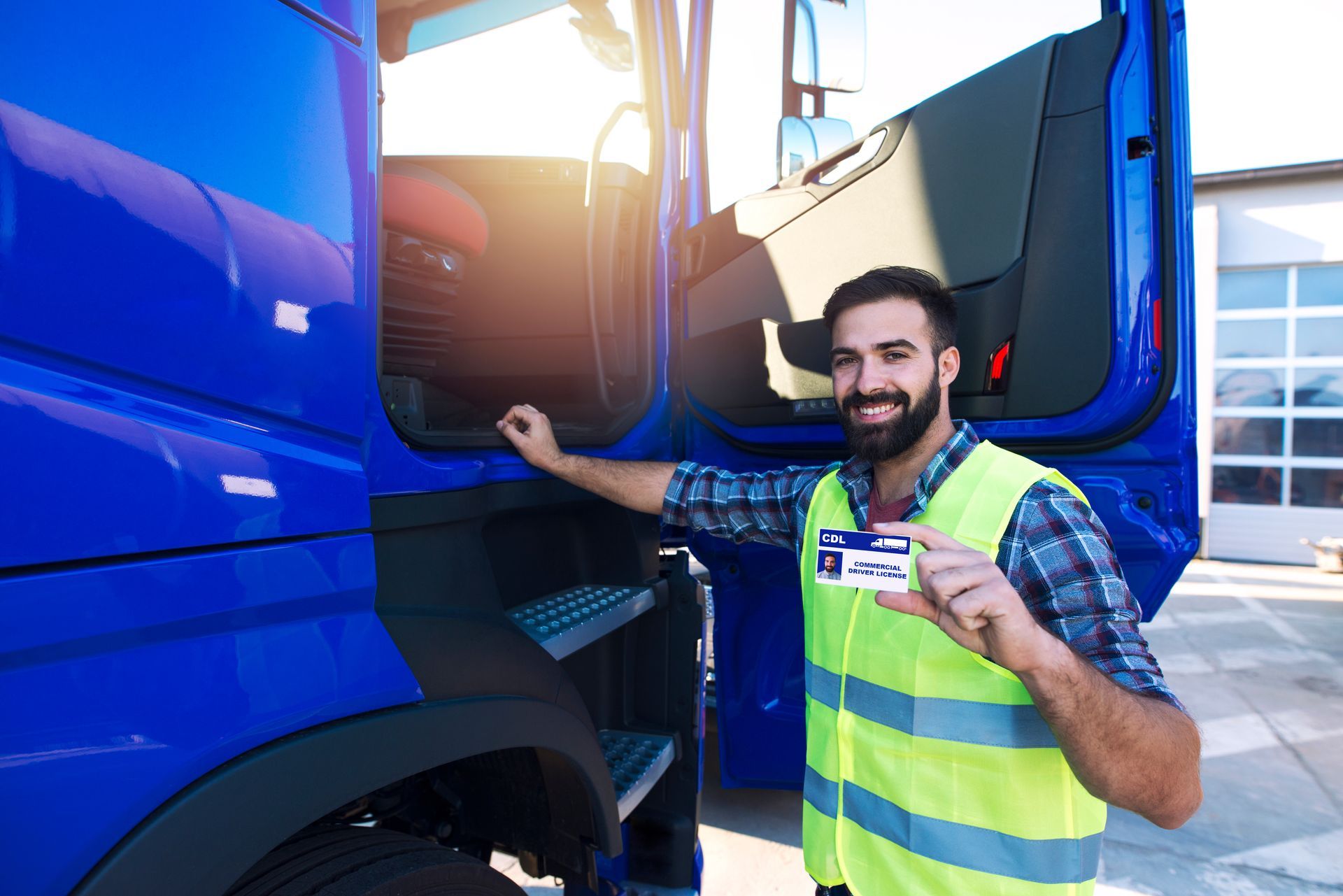 A driver candidate showing a heavy vehicle driving licence for transportation next to a truck.