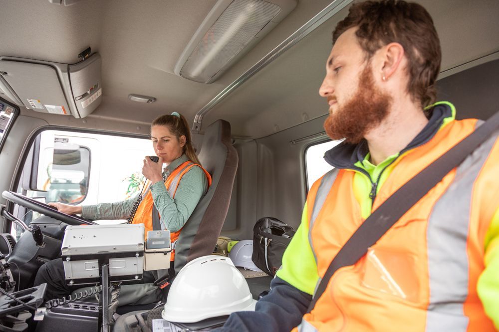 A female driving a heavy vehicle.