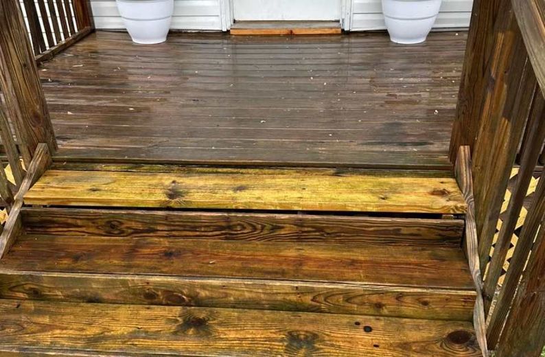 A wooden deck with stairs leading up to it.