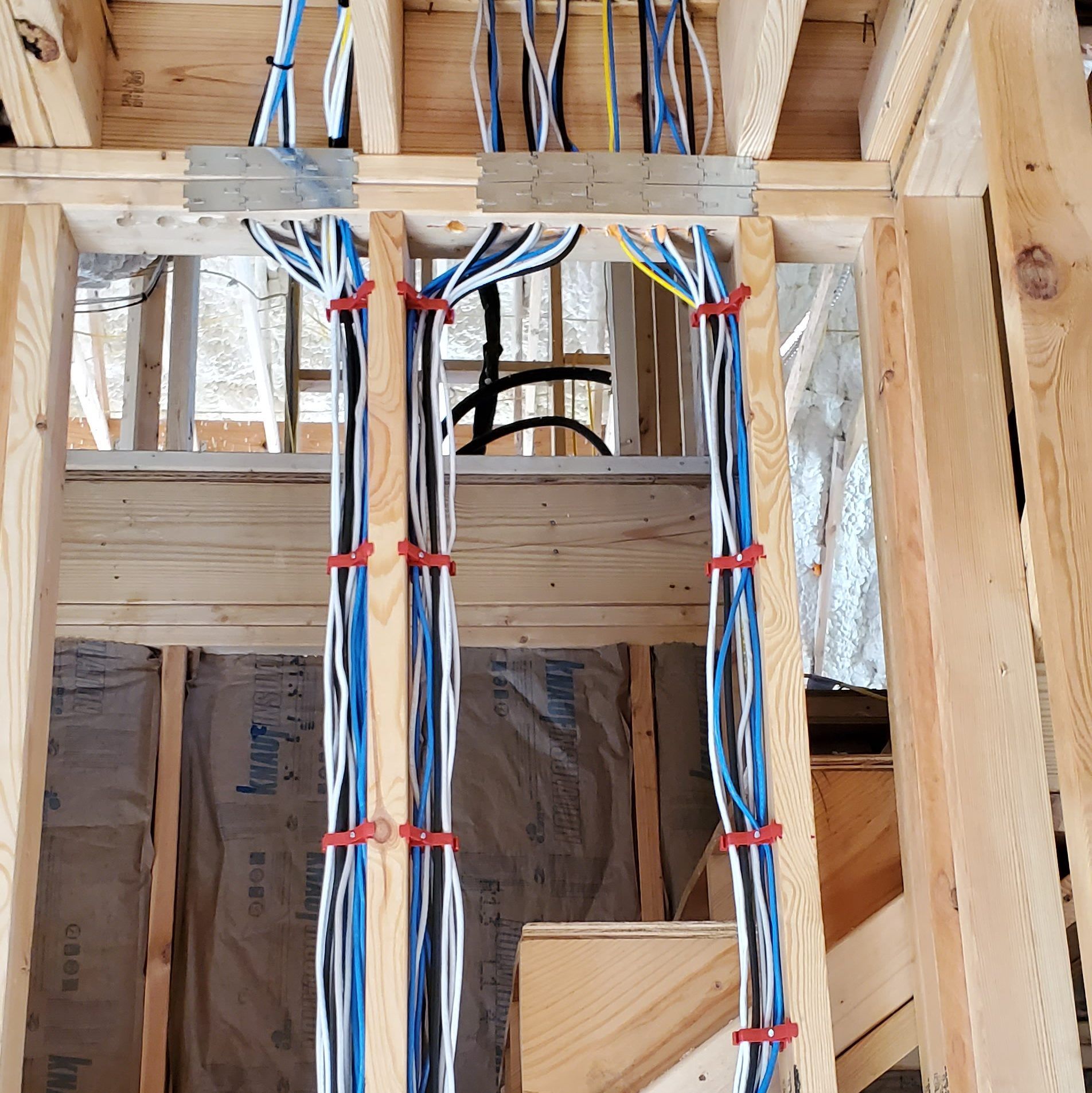 Electrical wiring in a wood-framed construction site.