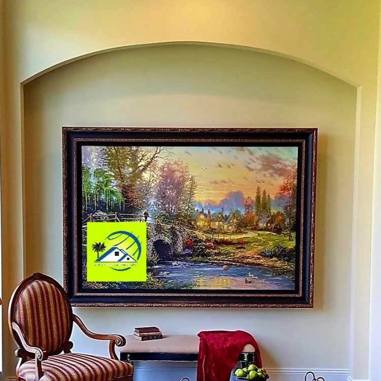 Large landscape painting above a small table and ornate chair; a red blanket and fruit basket are on the table.