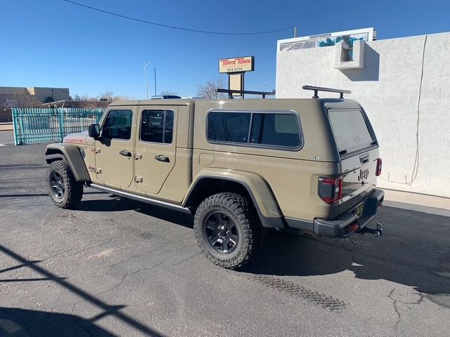 Red, red and silver trucks parked in a row, tires visible.