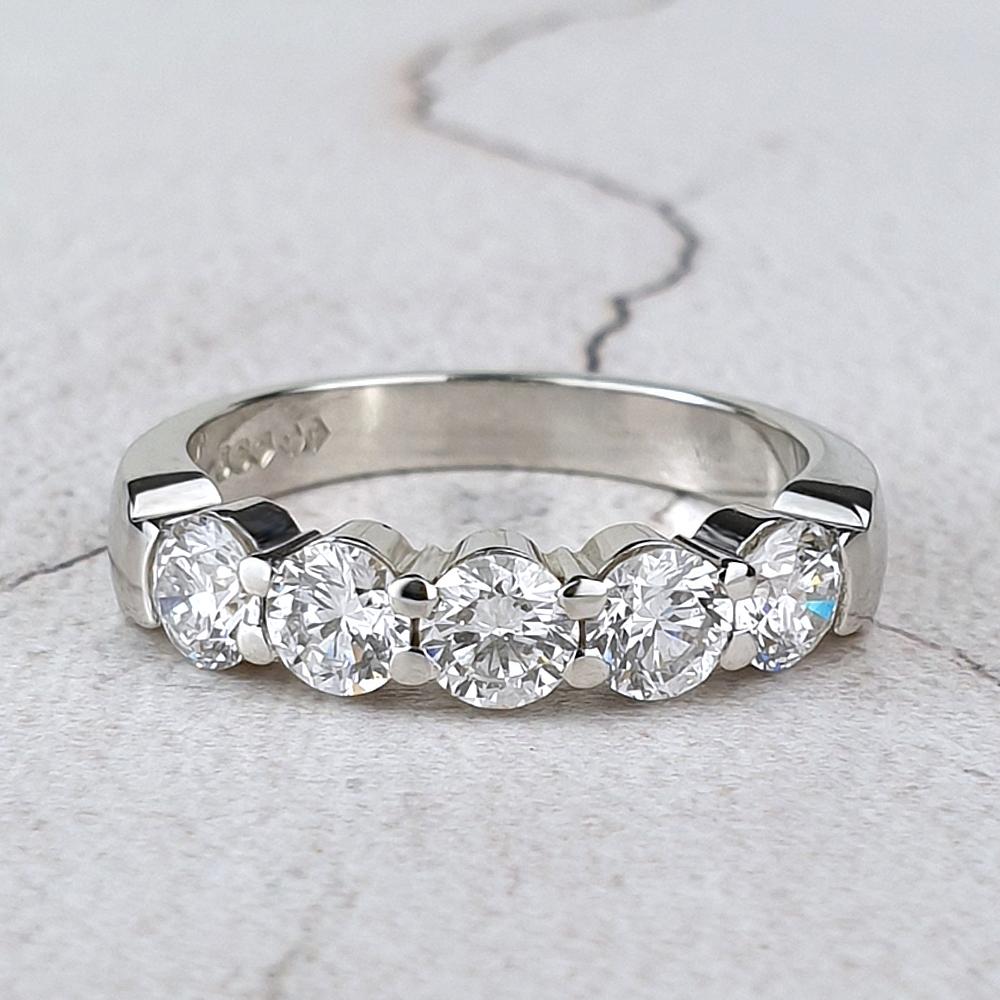 Platinum half eternity ring with five claw-set diamonds