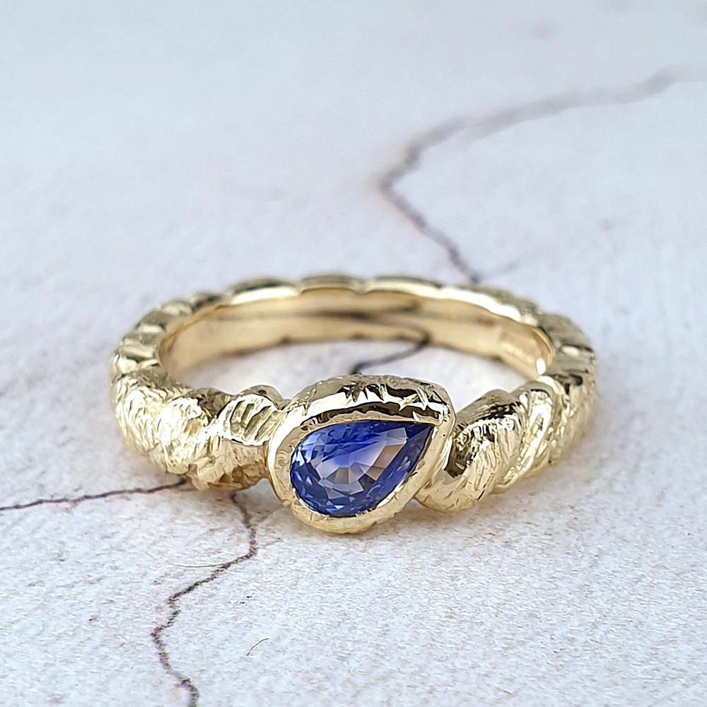 Unusual Rugged engagement ring with a sapphire