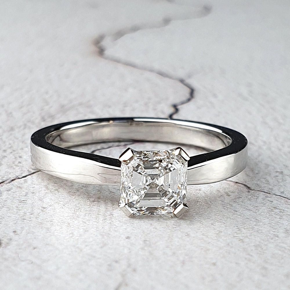 A single diamond engagement ring with an Asscher diamond in platinum