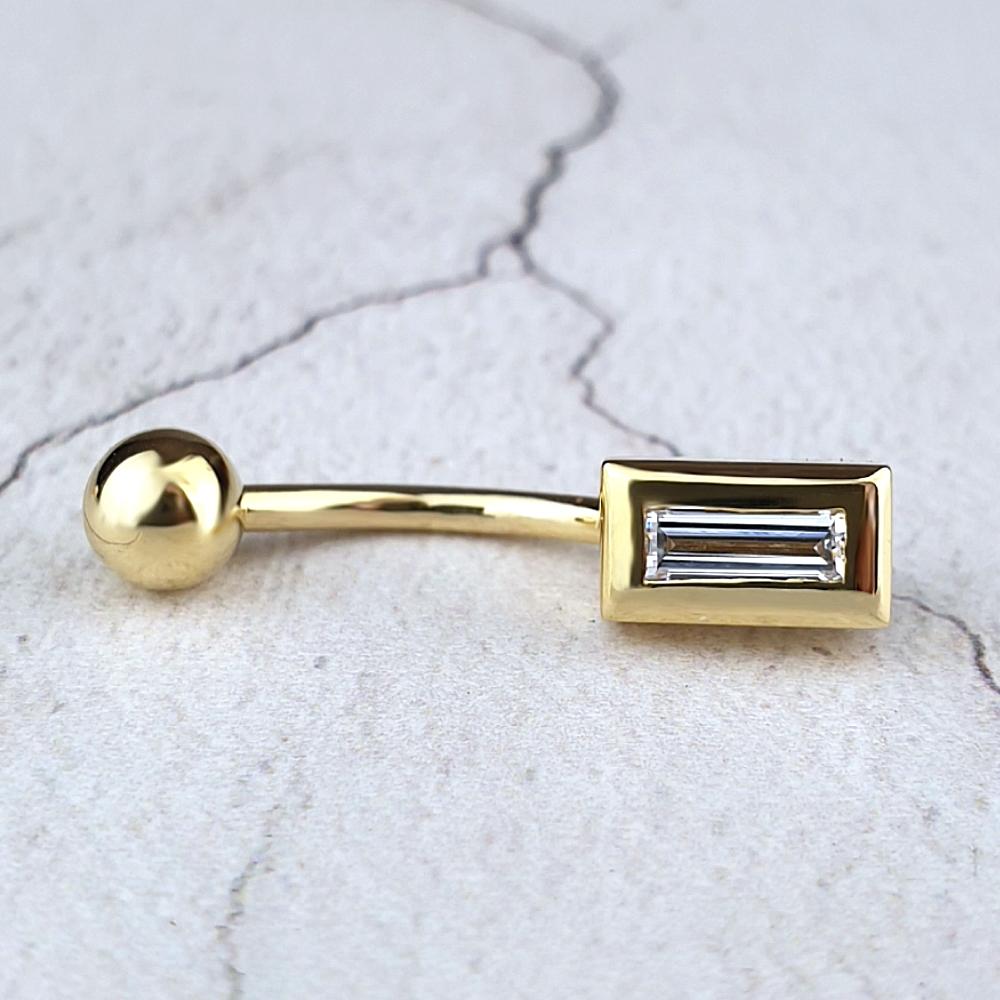 Gold navel bar with baguette diamond