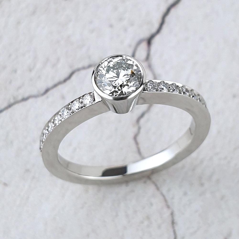 Cushion shaped halo ring with diamonds