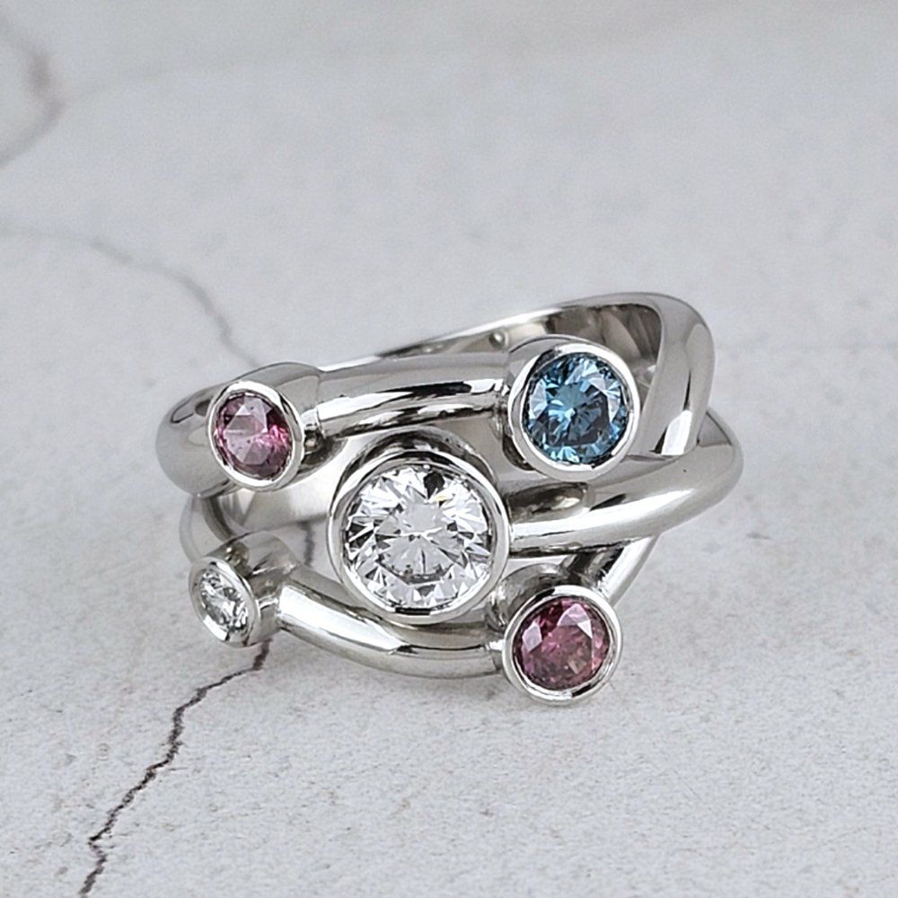 Bespoke platinum dress ring with stones to represent the customers family members