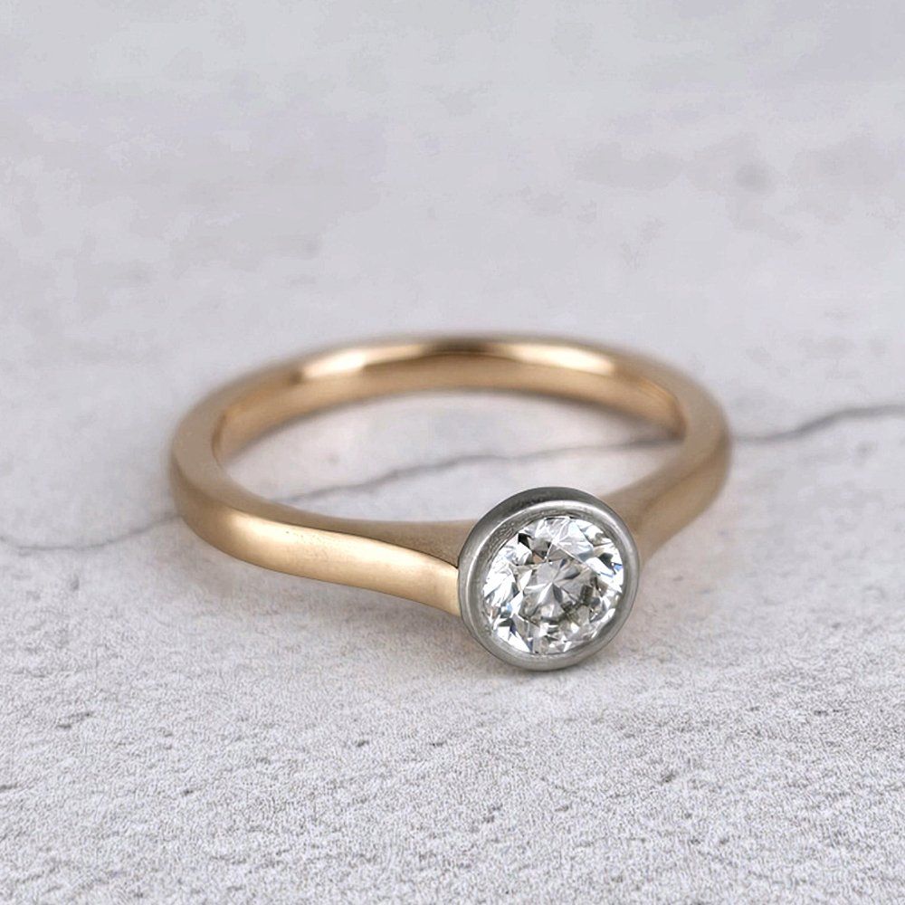 Platinum single diamond ring with round diamond on a red gold band