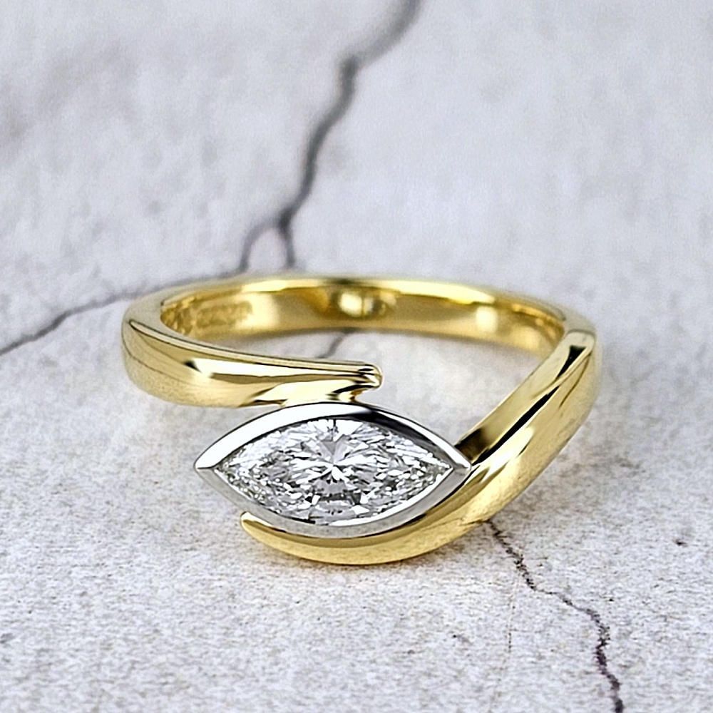 contemporary engagement ring with a marquise diamond set across the finger.