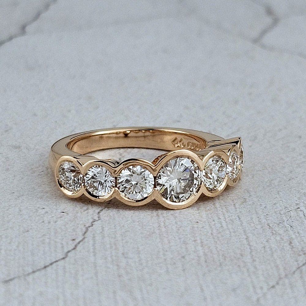 A seven-stone diamond half hoop engagement ring