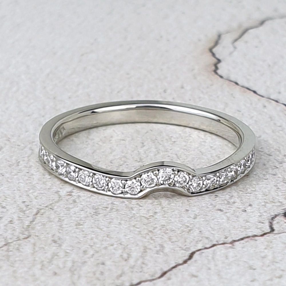 narrow platinum wedding ring with small diamonds