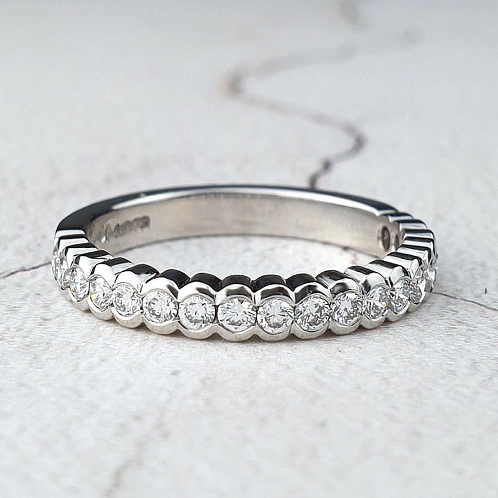 Platinum wedding ring with diamonds in scalloped setting