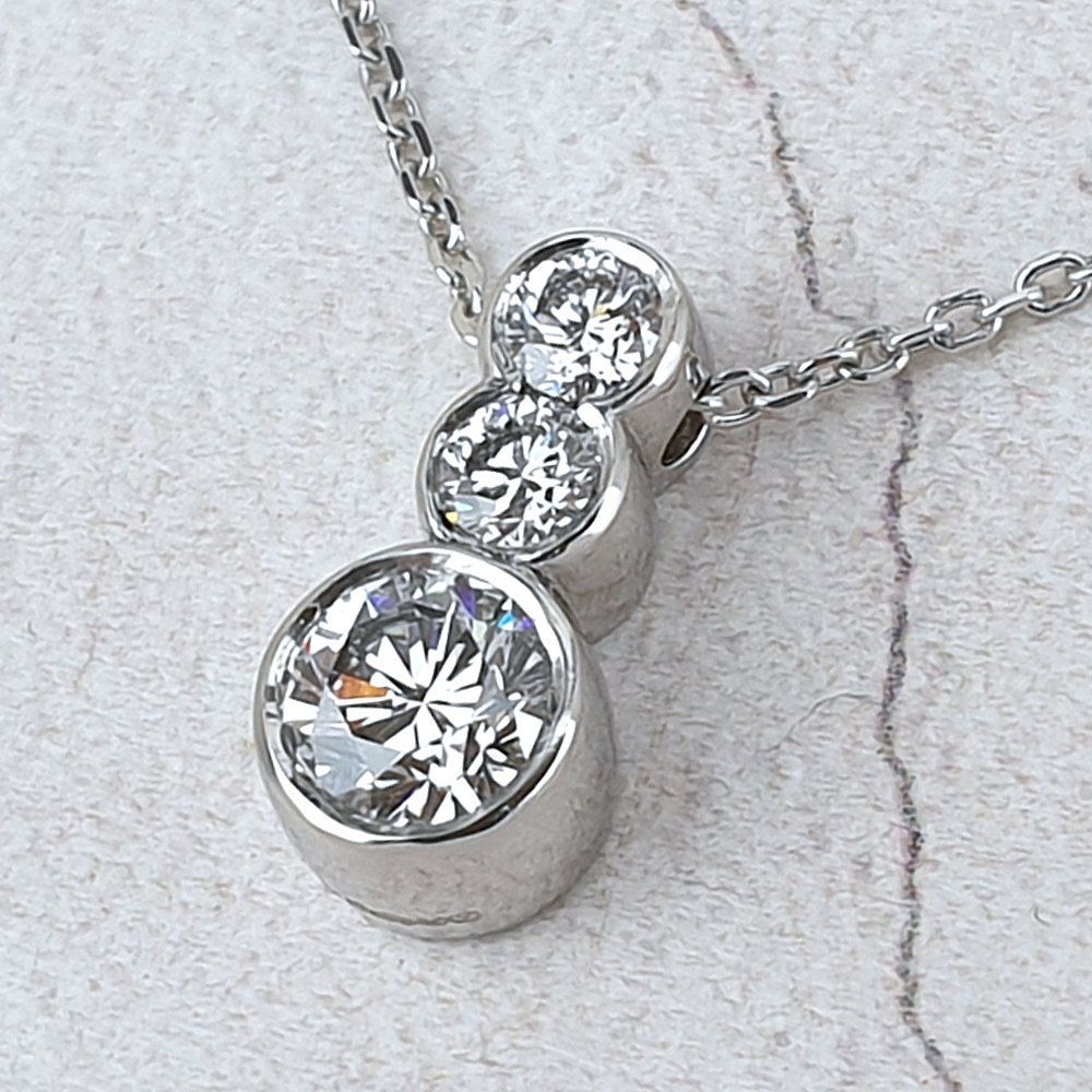 Remodelled platinum pendant with three recycled diamonds