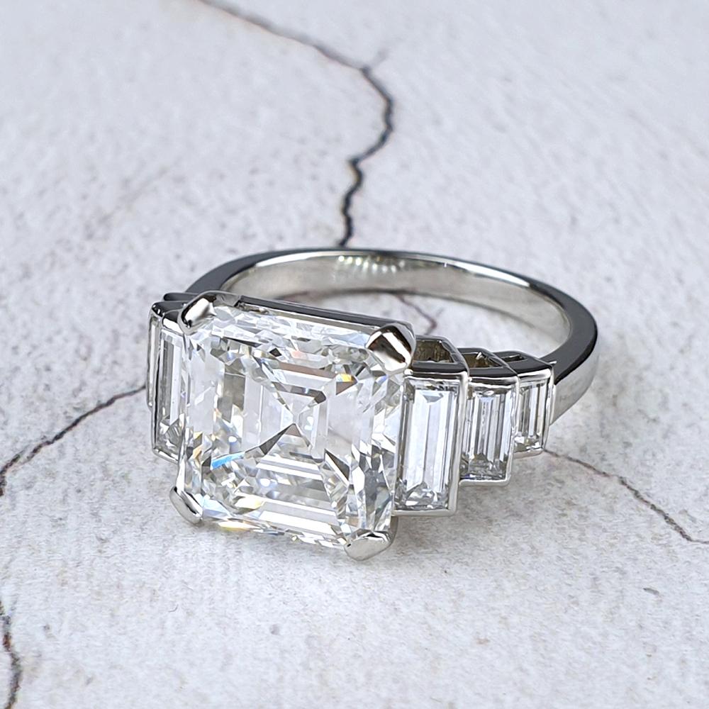Emerald cut diamond engagement ring with baguette shoulders