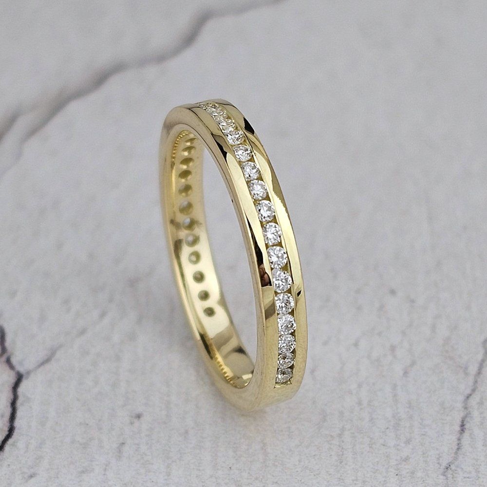 yellow gold wedding ring with channel-set diamonds
