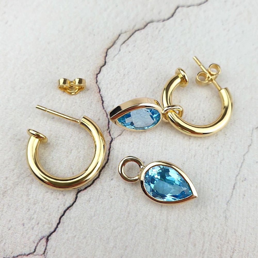 Hoop earrings with blue topaz attachments