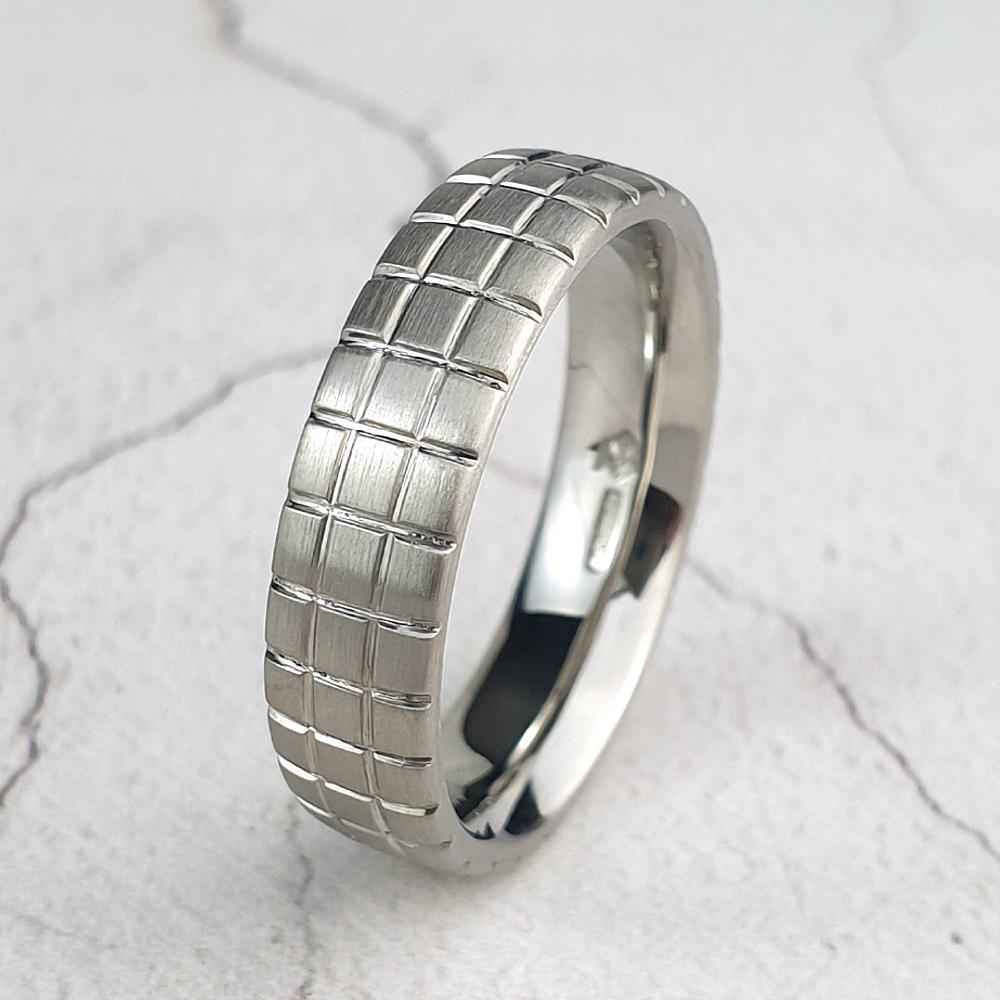 Mans platinum wedding ring with grooved cut both ways