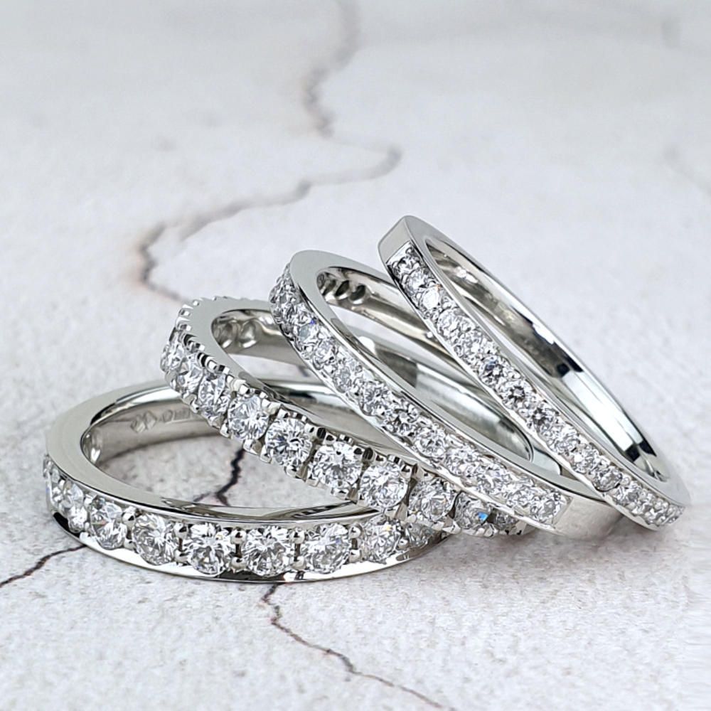 Three platinum wedding rings with micro-pavé diamonds