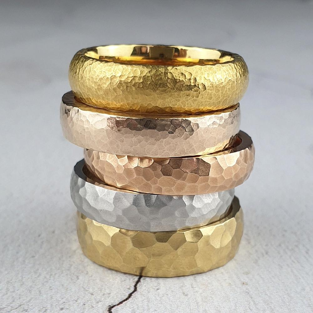 Wedding rings with different hammered finishes