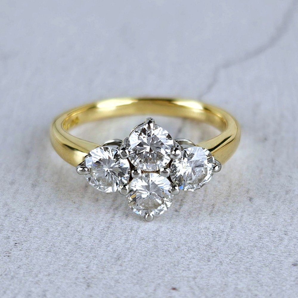 Cluster engagement ring with four diamonds in platinum on a gold band