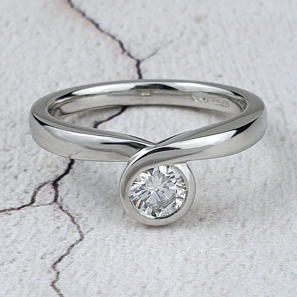 Cushion shaped halo ring with diamonds