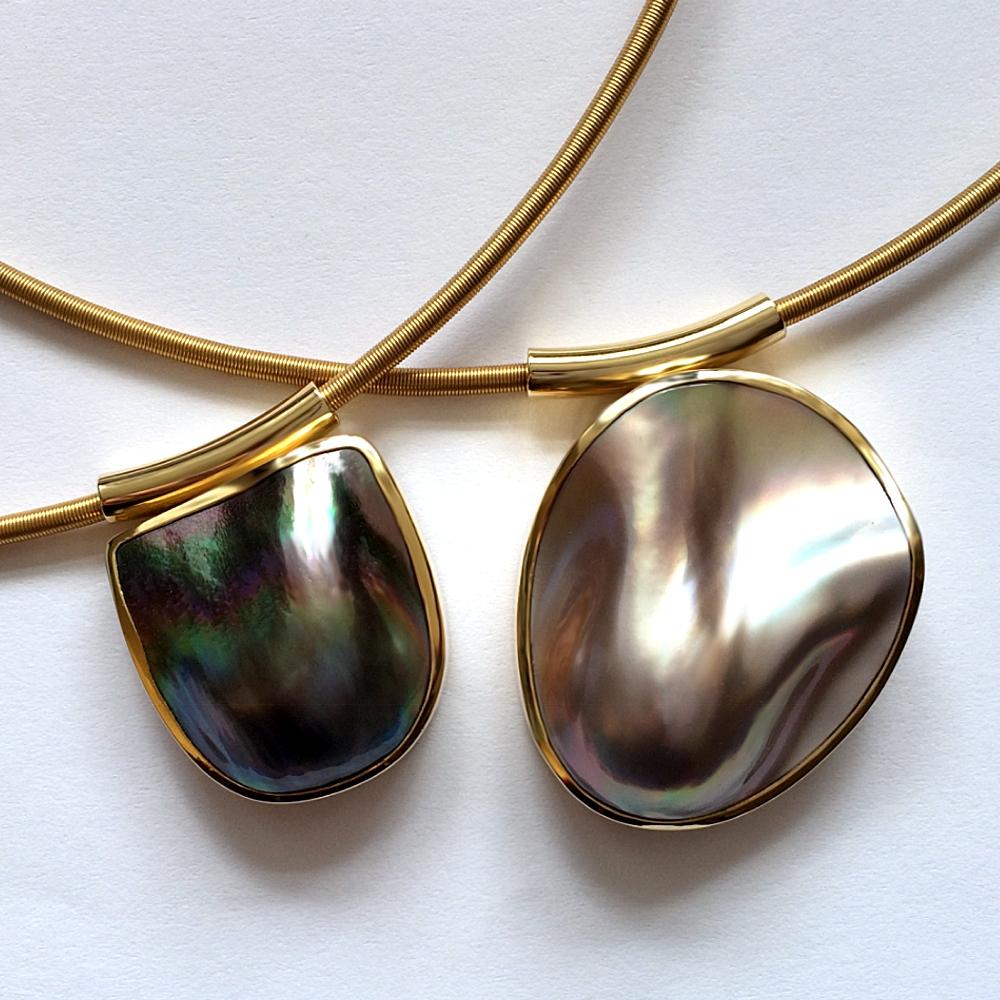 18ct gold pendants with mabé pearls.