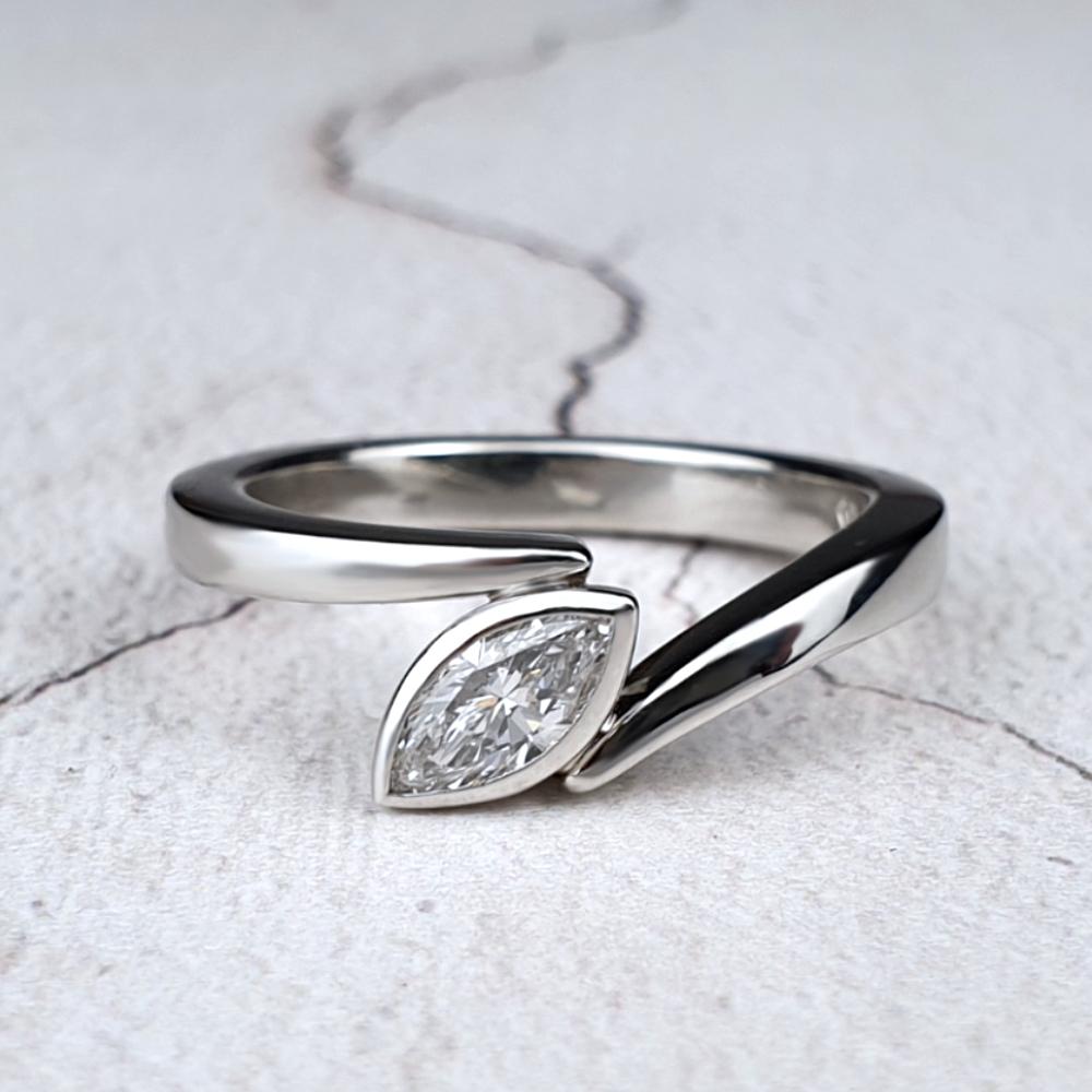 Polished platinum Flick engagement rings with a marquise diamond