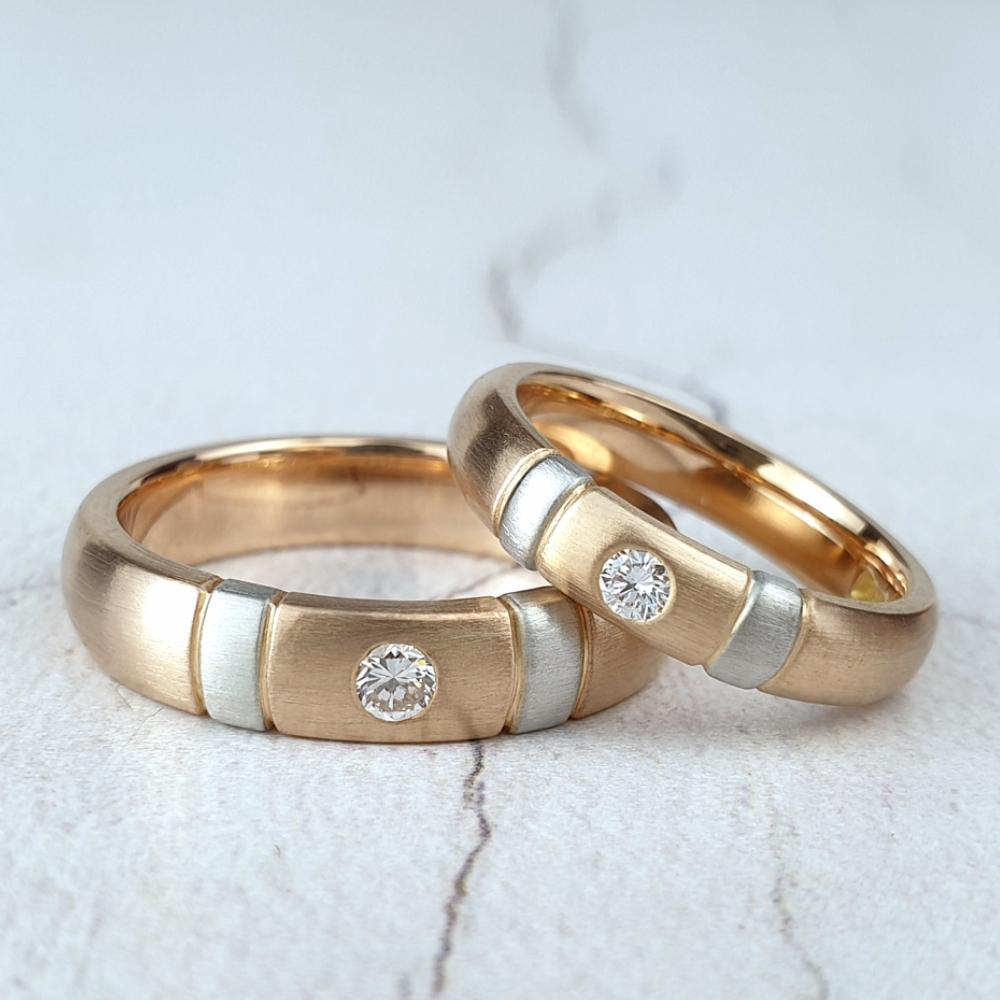 Matching red gold wedding rings with one diamond